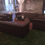 Brown Tufted Leather lounge furniture, Wine Cork Coffee Table, and Silver Metal Lantern